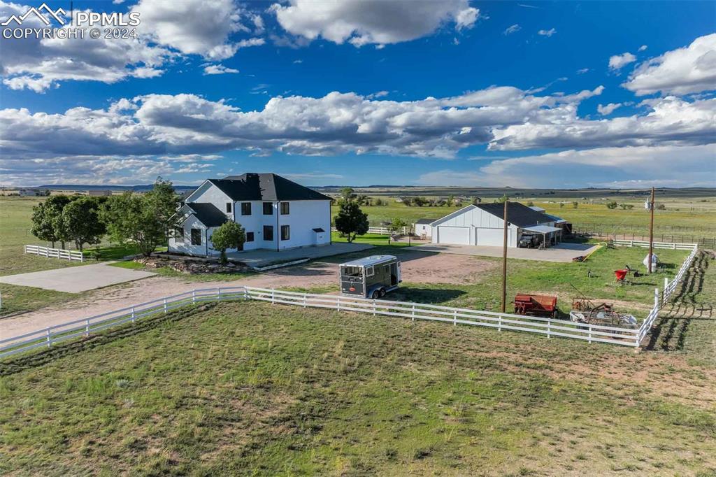 View of yard with a garage and a rural view