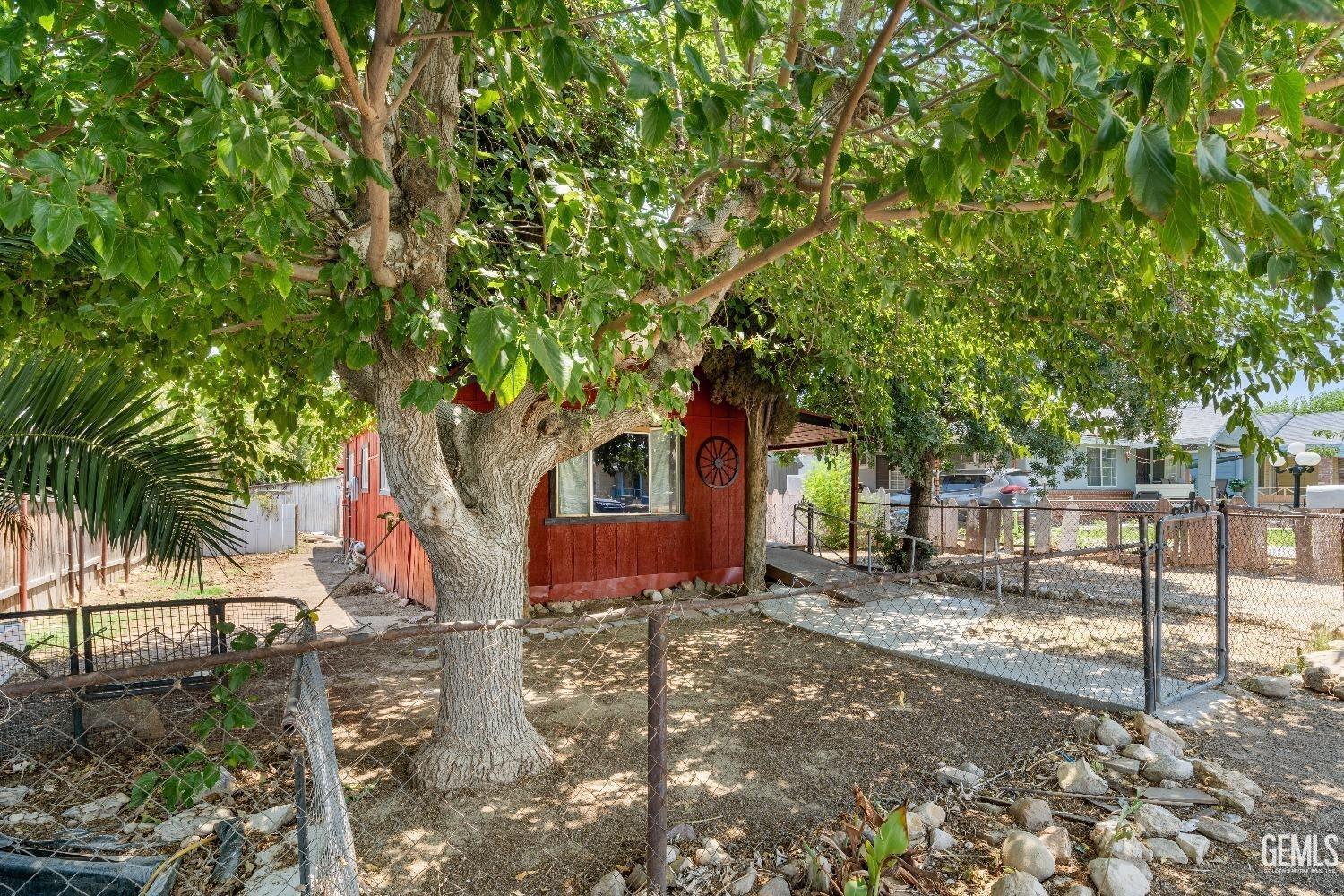 a backyard of a house with table and chairs