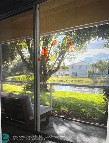 a view of a glass door with a yard