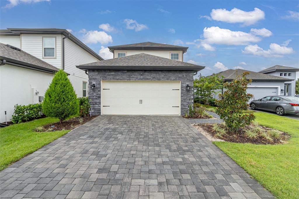 a front view of a house with a yard and garage