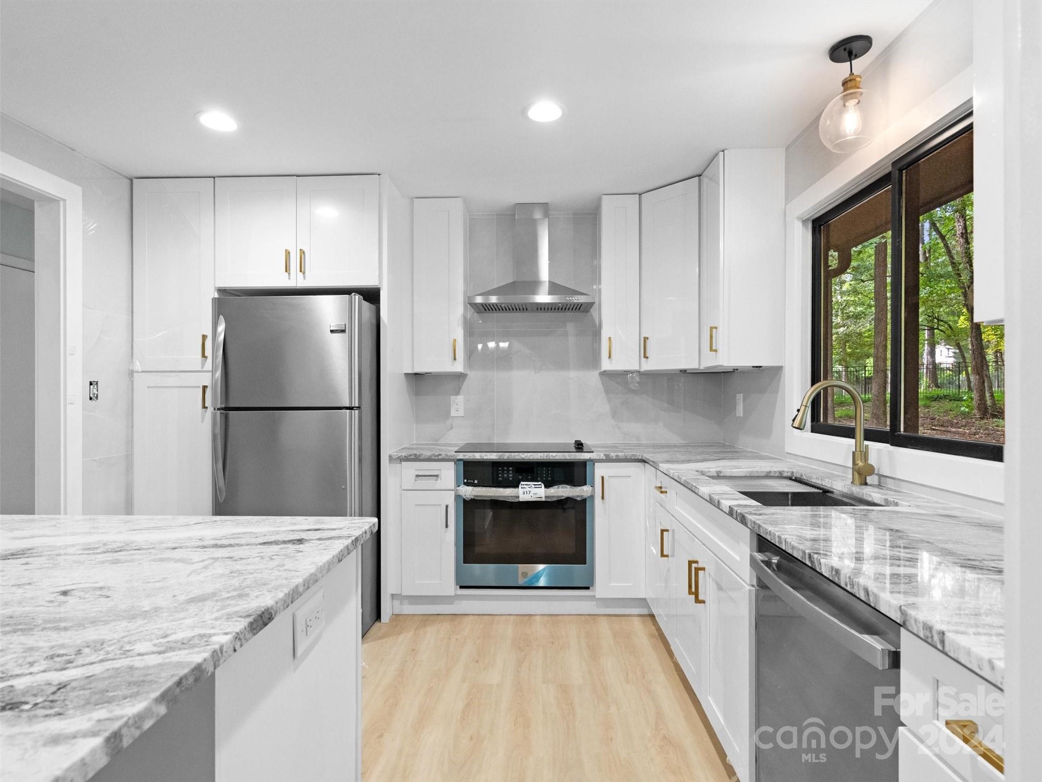 a kitchen with a stove a sink and a refrigerator