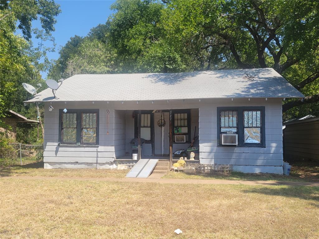 a front view of a house with a yard table and chairs