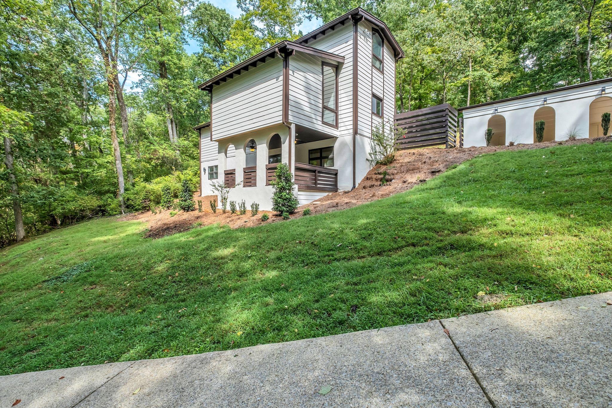 a front view of house with yard and green space