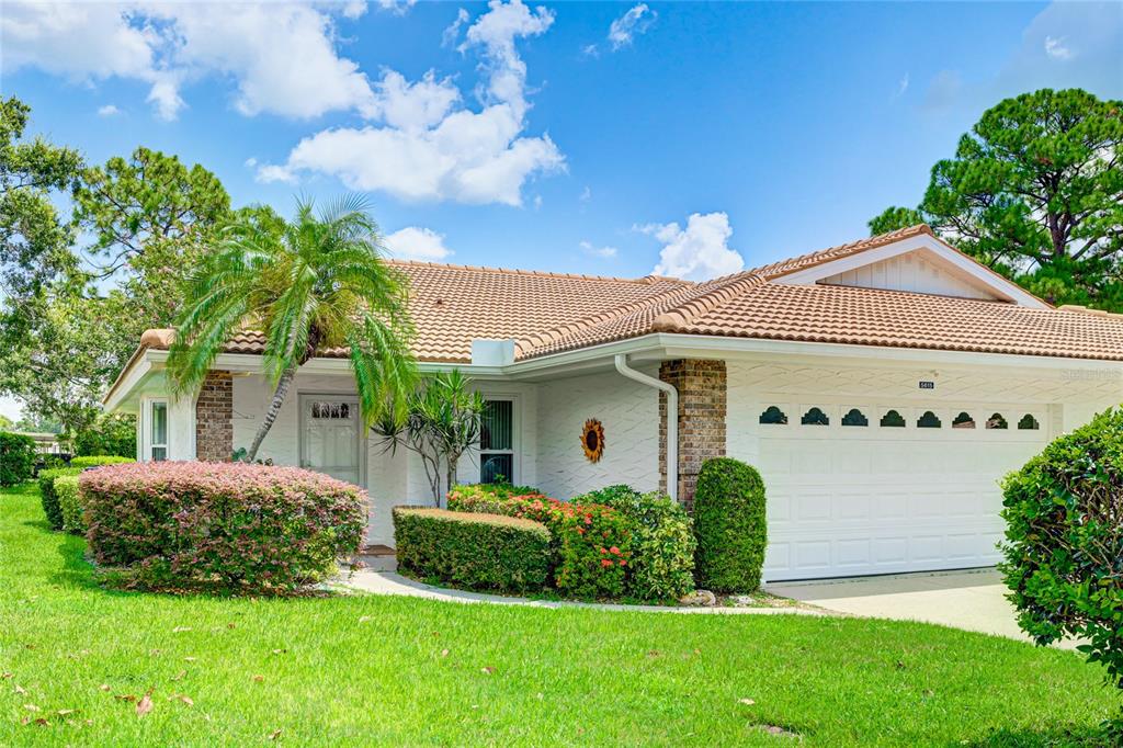 a front view of a house with a garden