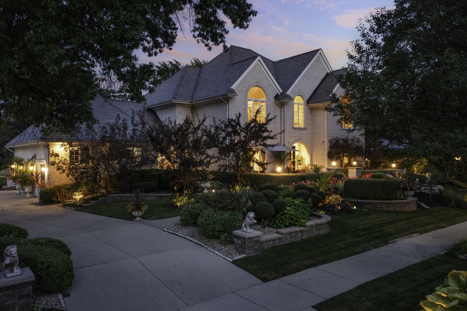 a front view of a house with a yard and outdoor seating