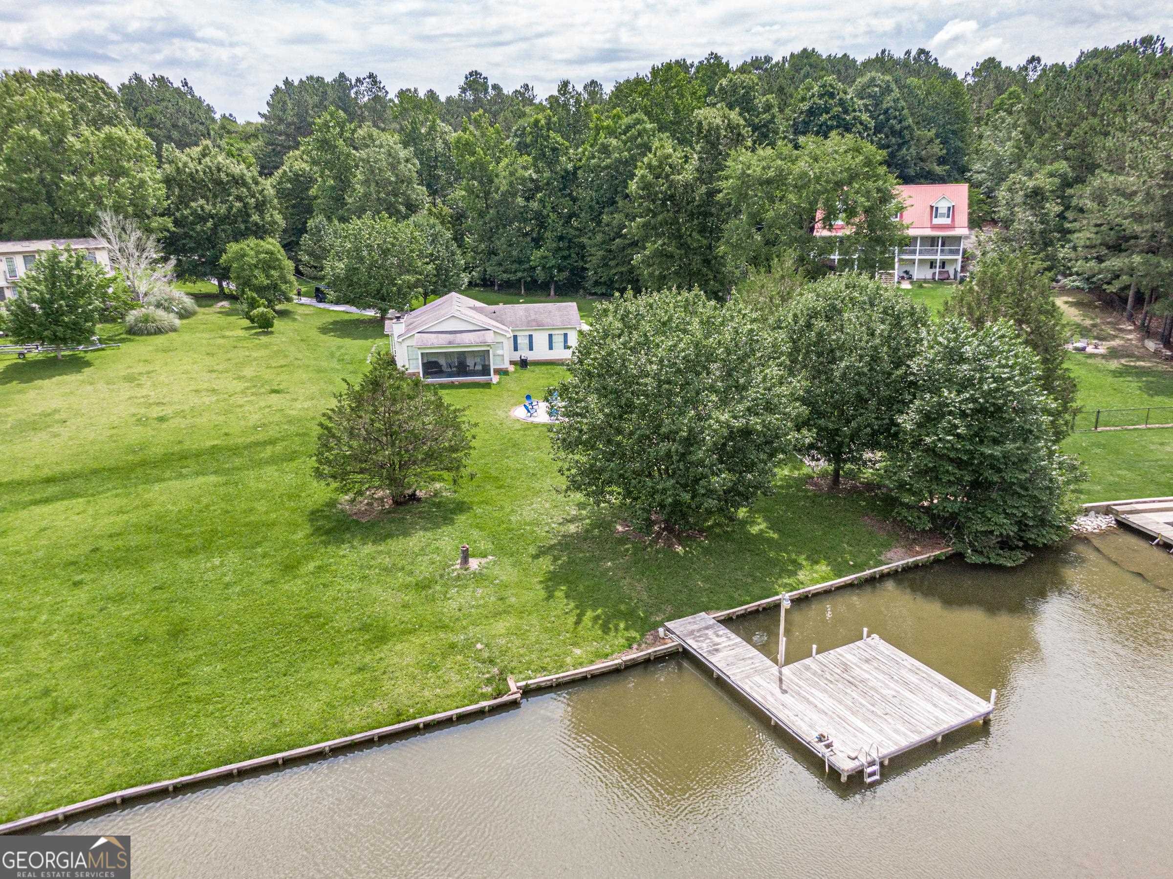 a view of a house with pool and a yard