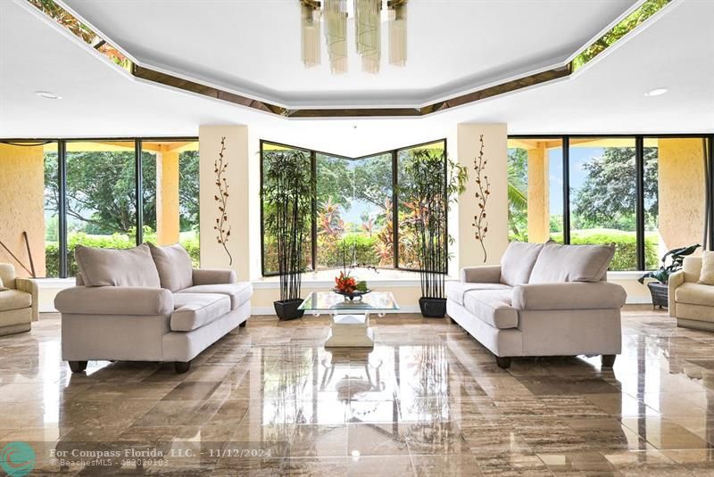 a living room with furniture and large windows