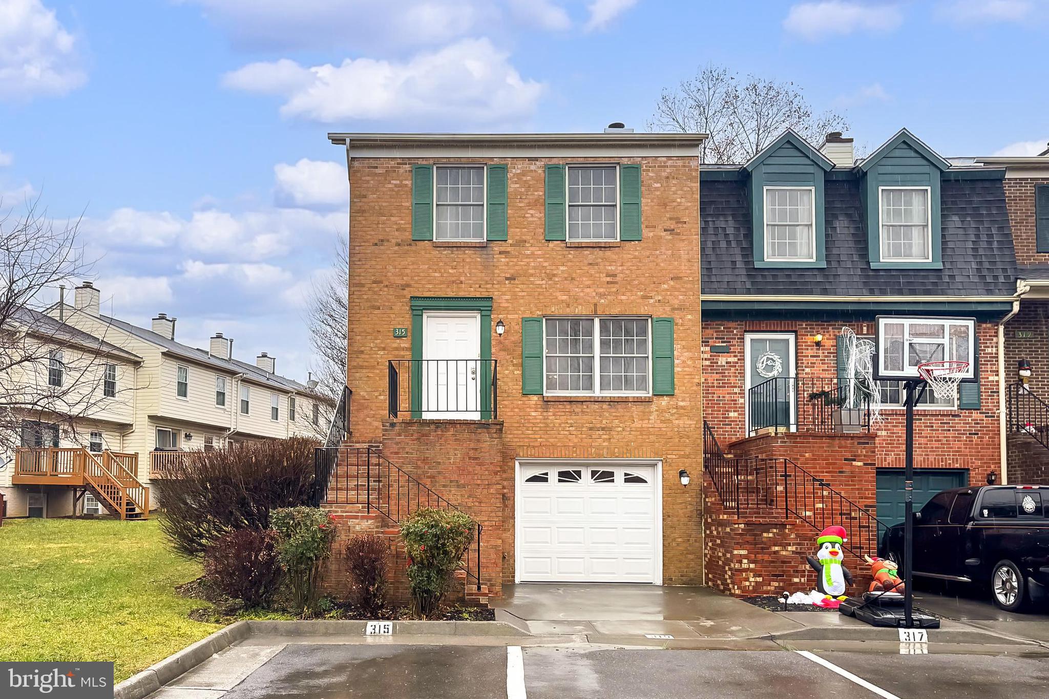 a front view of a house with a parking lot