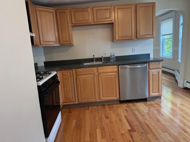 a kitchen with granite countertop wooden cabinets a sink and dishwasher