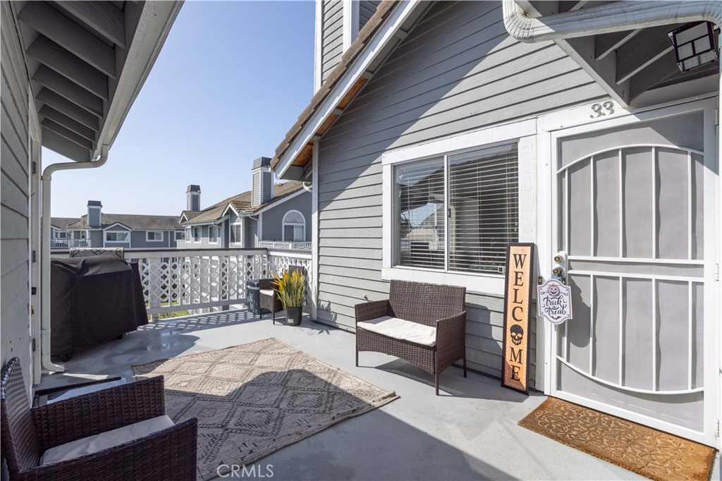 a balcony with a couch and wooden floor