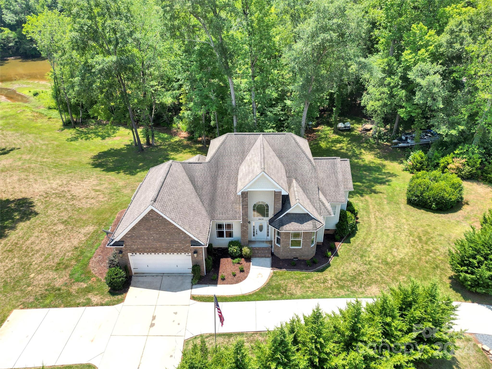 a aerial view of a house with swimming pool garden and patio