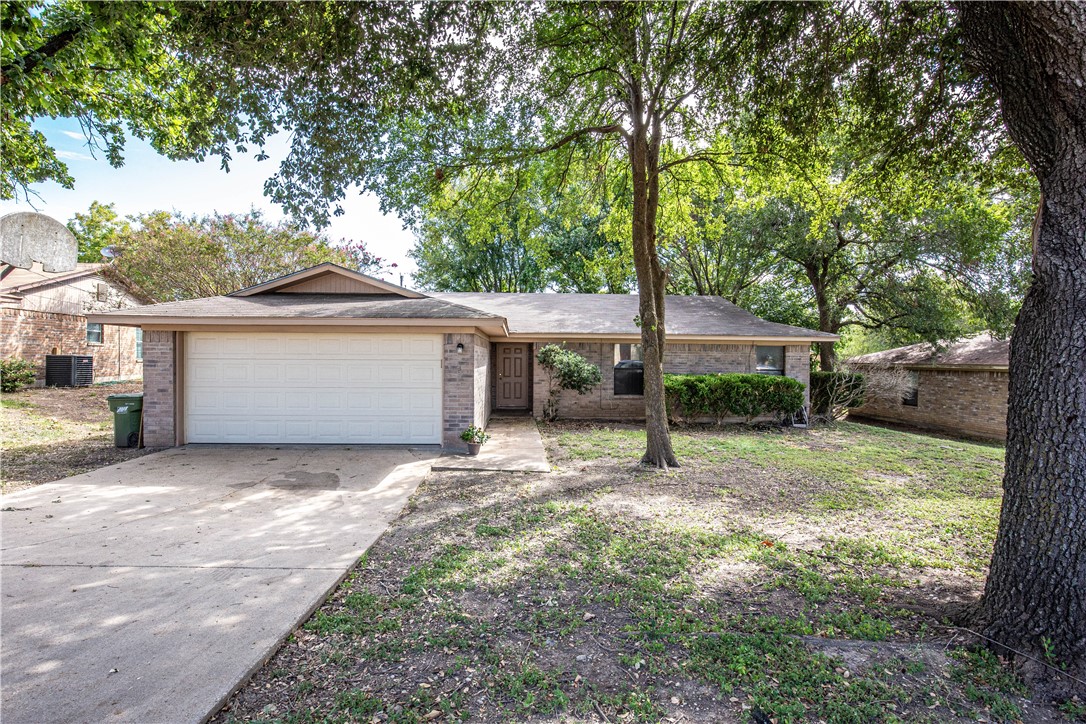 a view of a house with a yard and tree