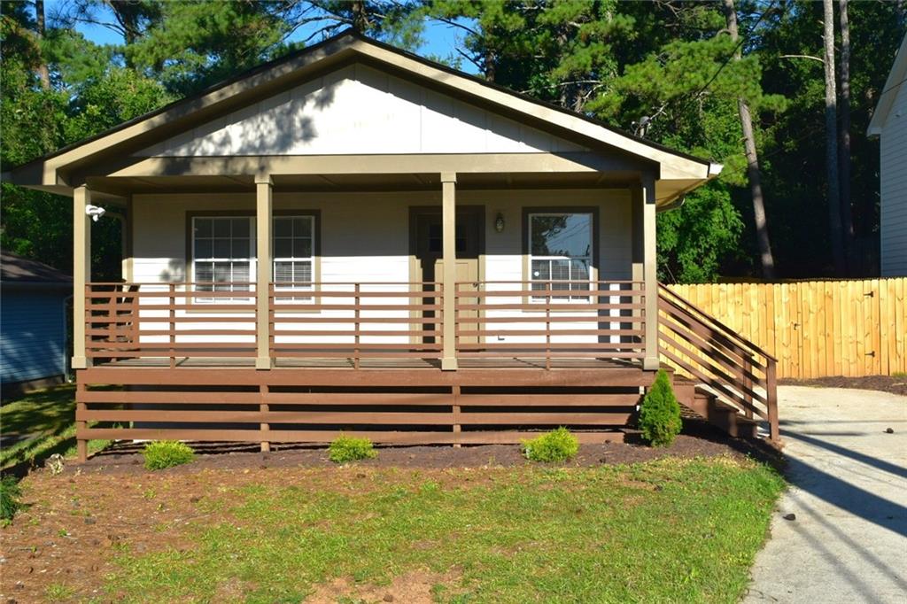 a view of house with backyard