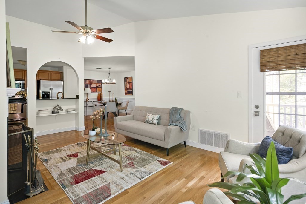 a living room with furniture a rug and a window