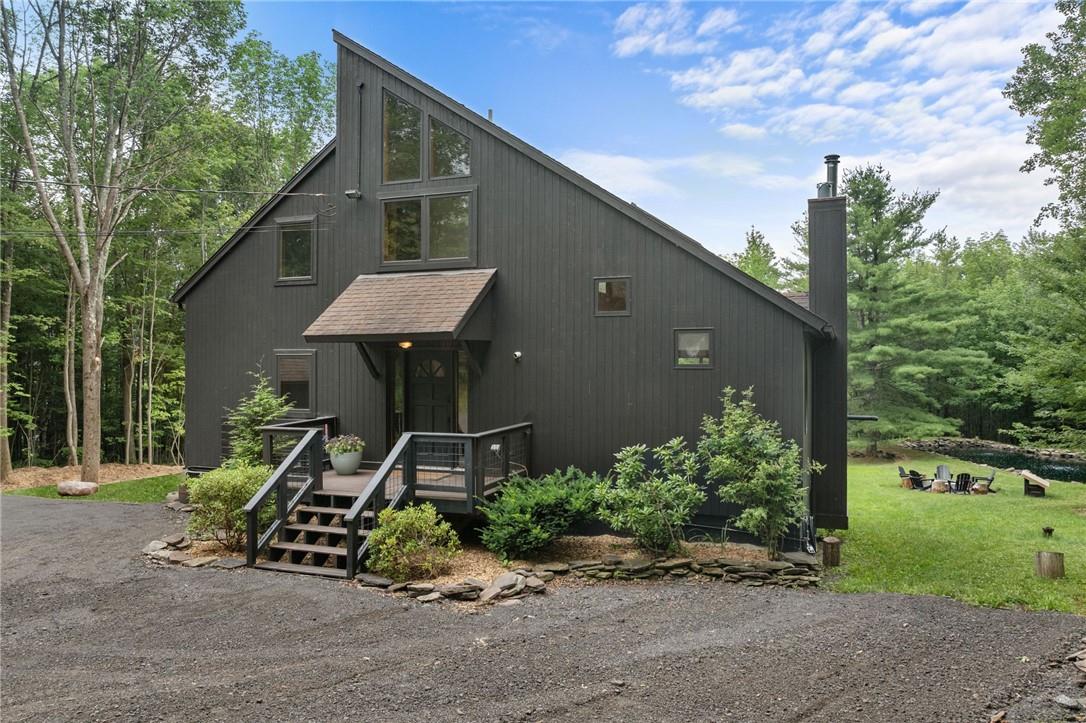 View of front of home featuring a wooden deck