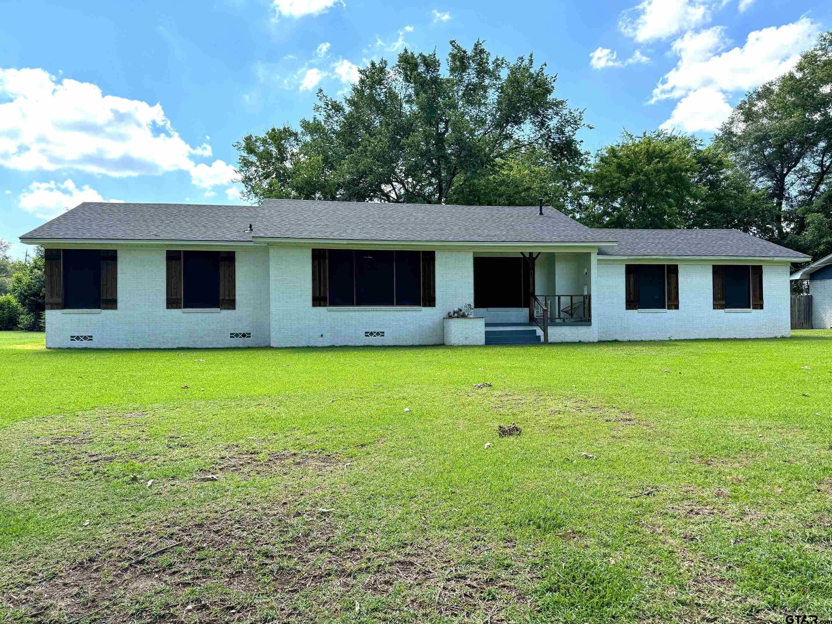 a front view of house with yard and glass windows