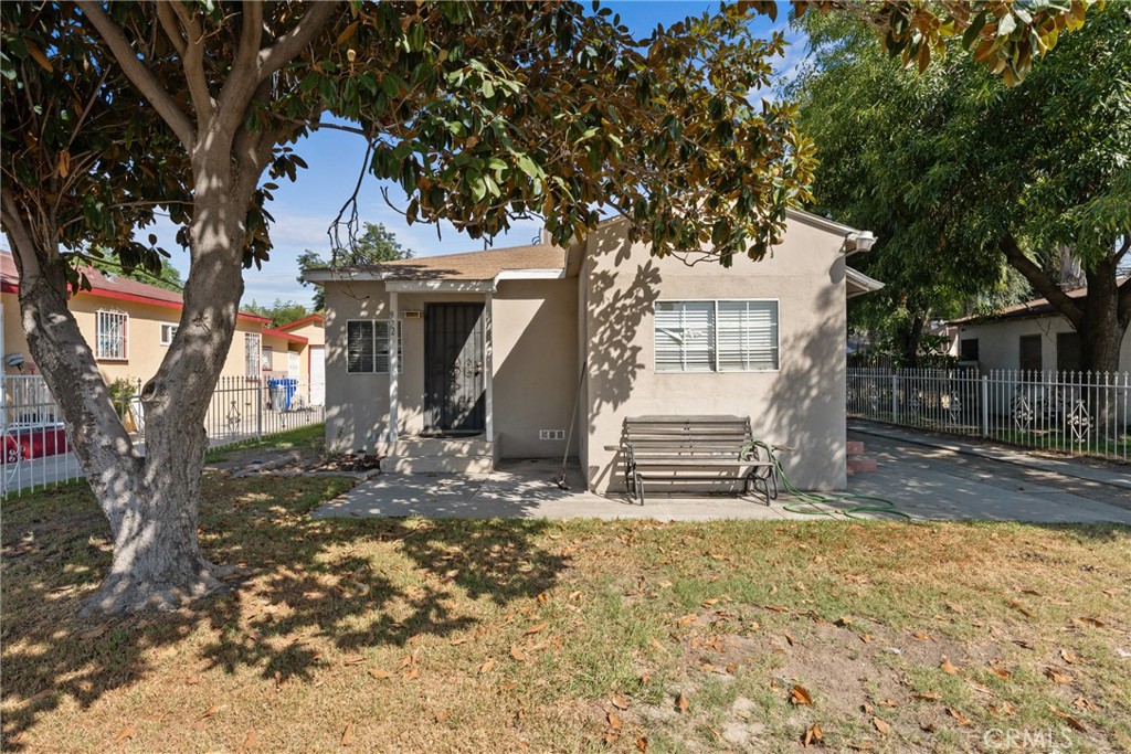 a view of a house with a tree in the yard