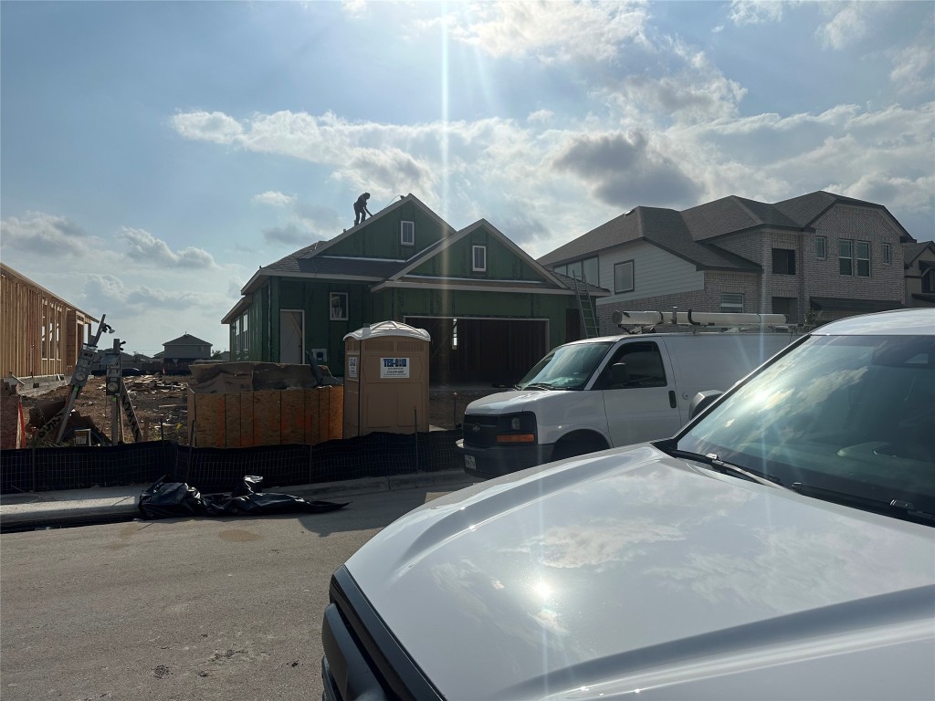 a front view of a house with cars