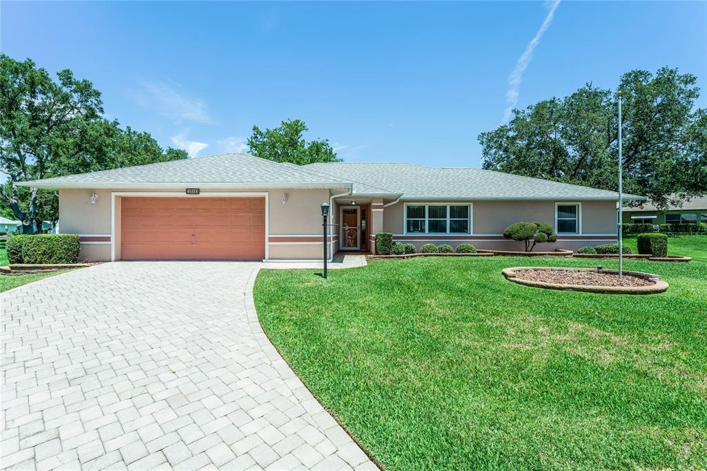 a front view of house with yard and green space