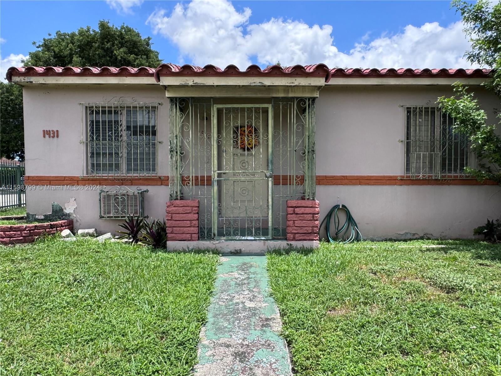 a view of a house with a yard and sitting area