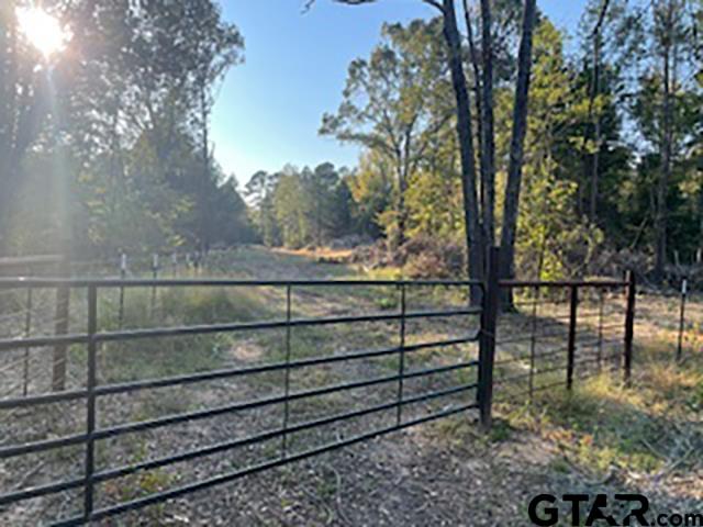 a view of a wooden fence and trees