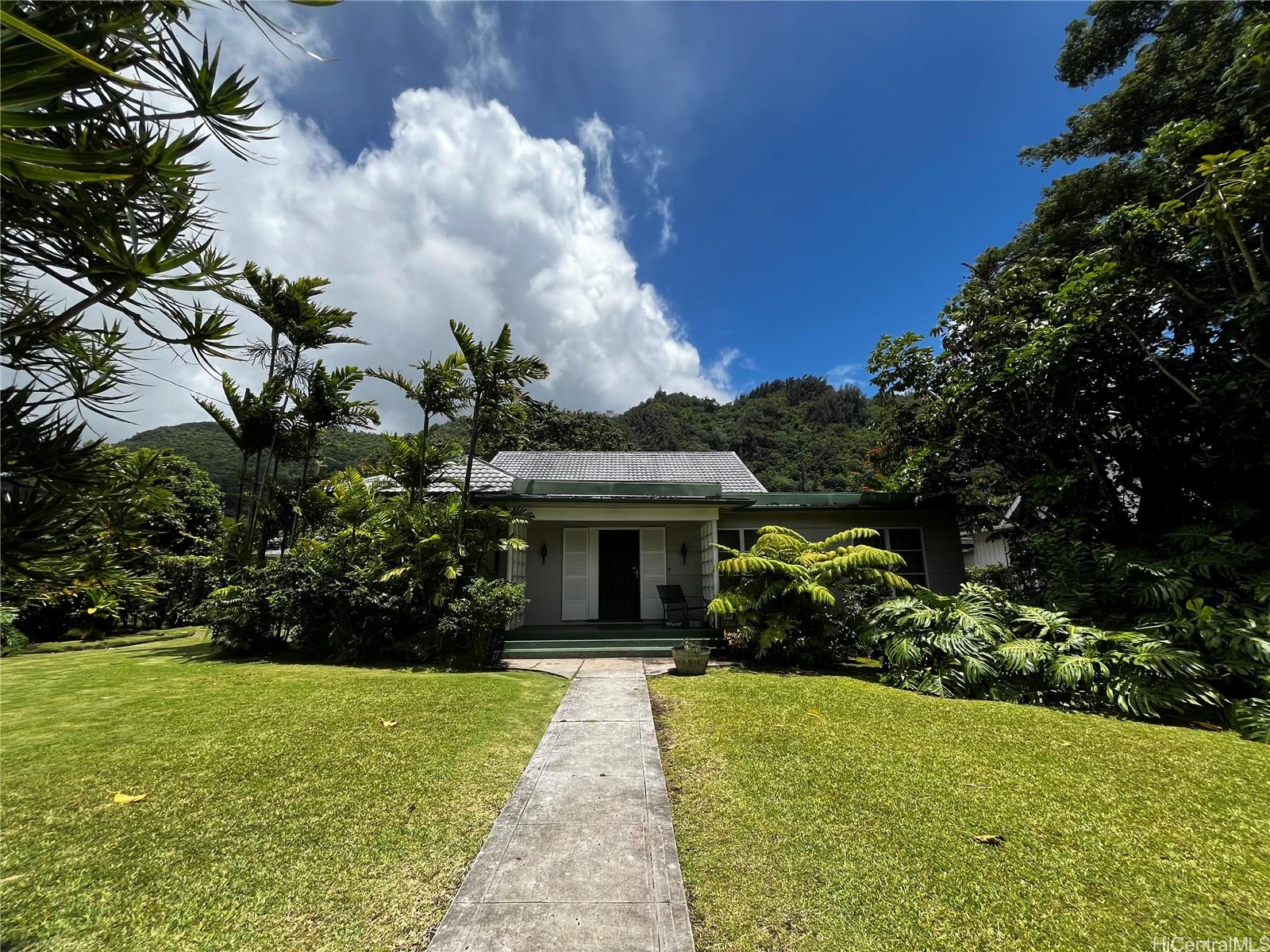 a front view of house with yard and green space