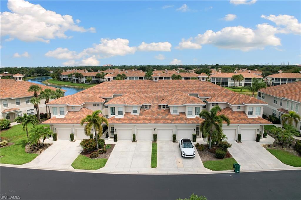 an aerial view of residential houses with outdoor space and ocean view