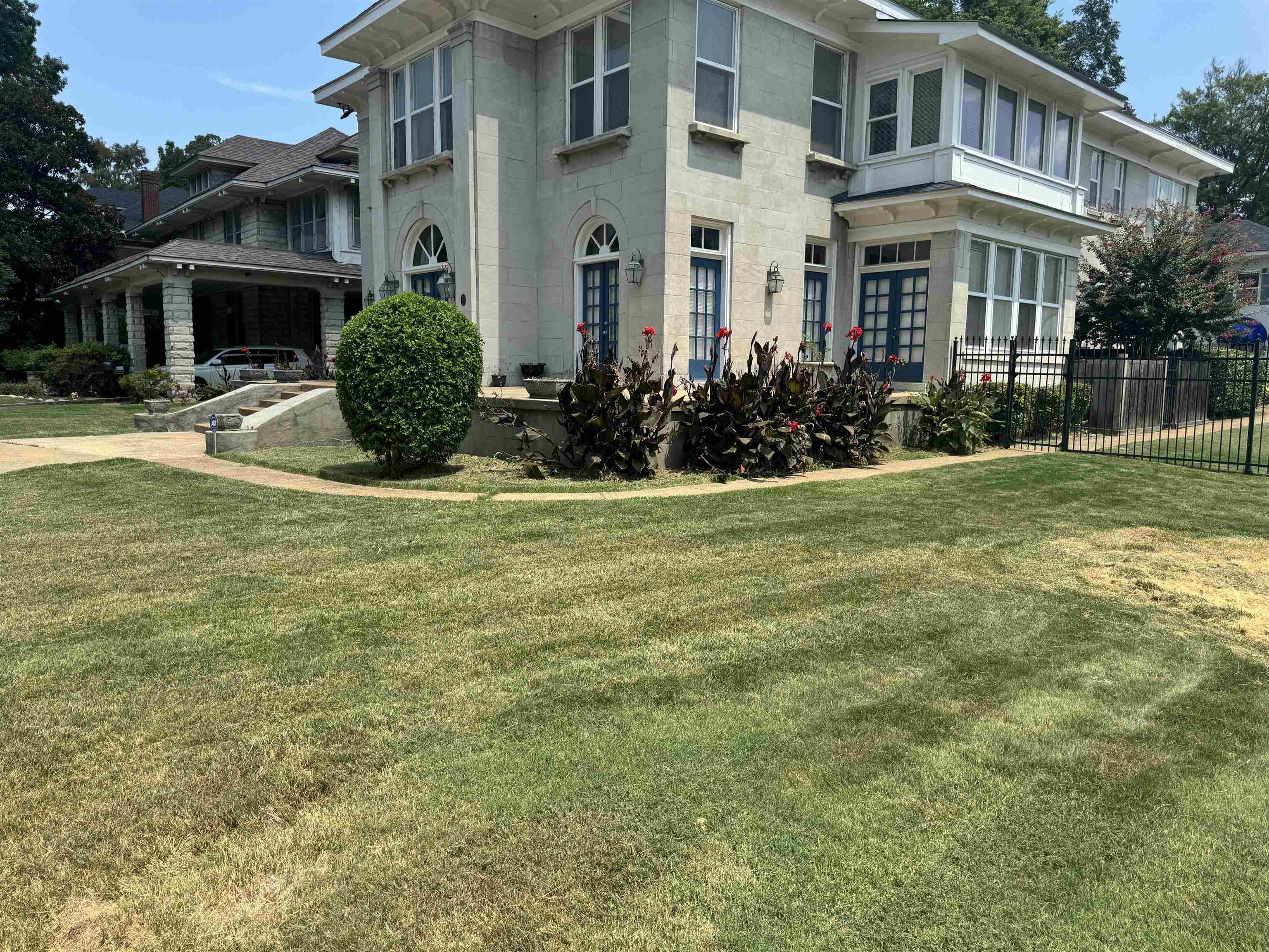 a front view of a residential apartment building with a yard