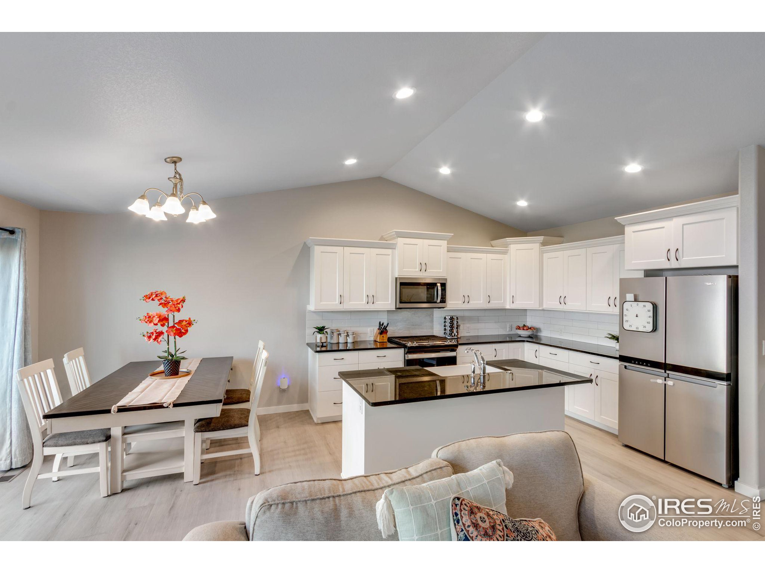 a kitchen view with microwave a stove and cabinets