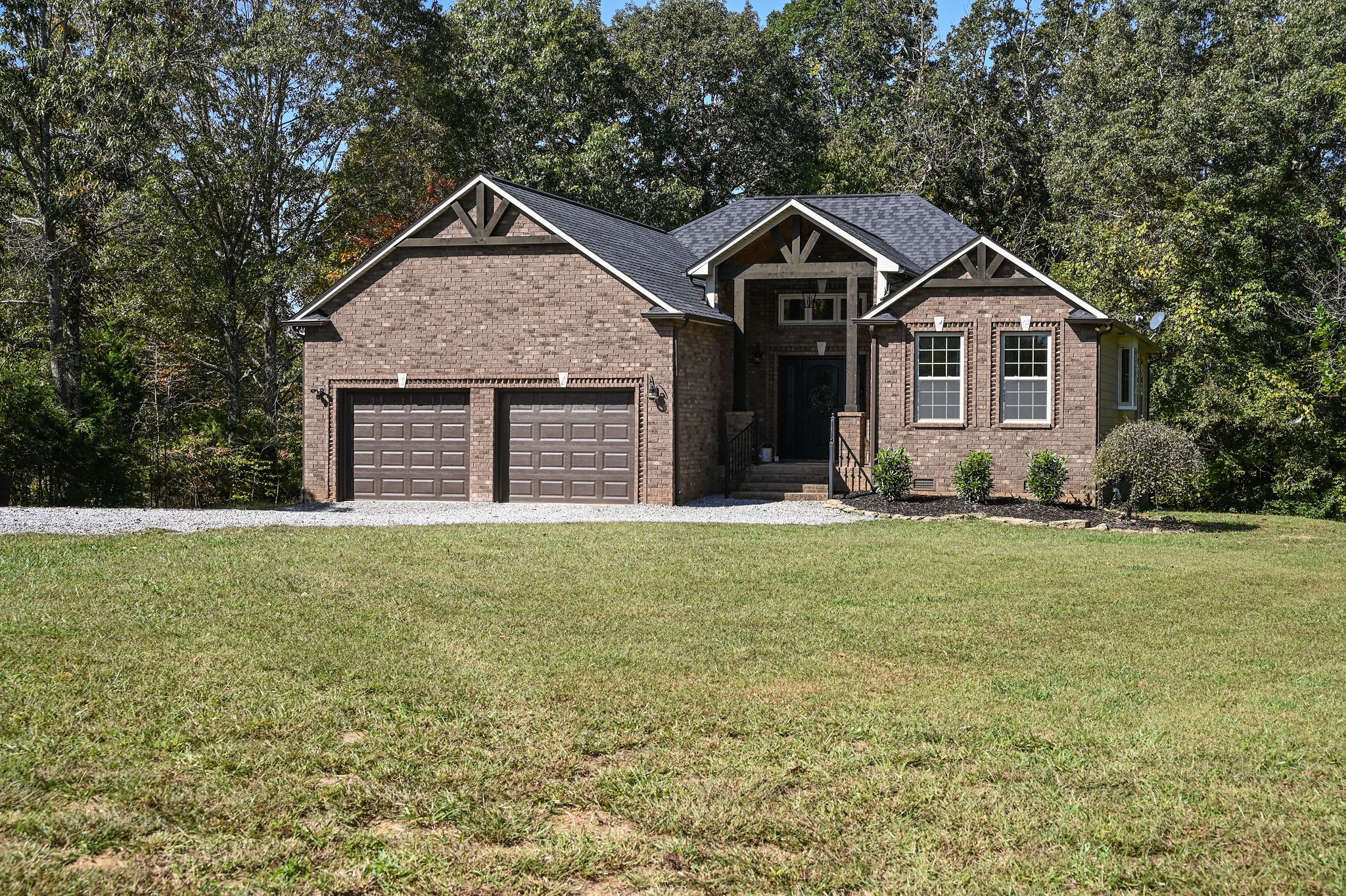 a front view of a house with a garden