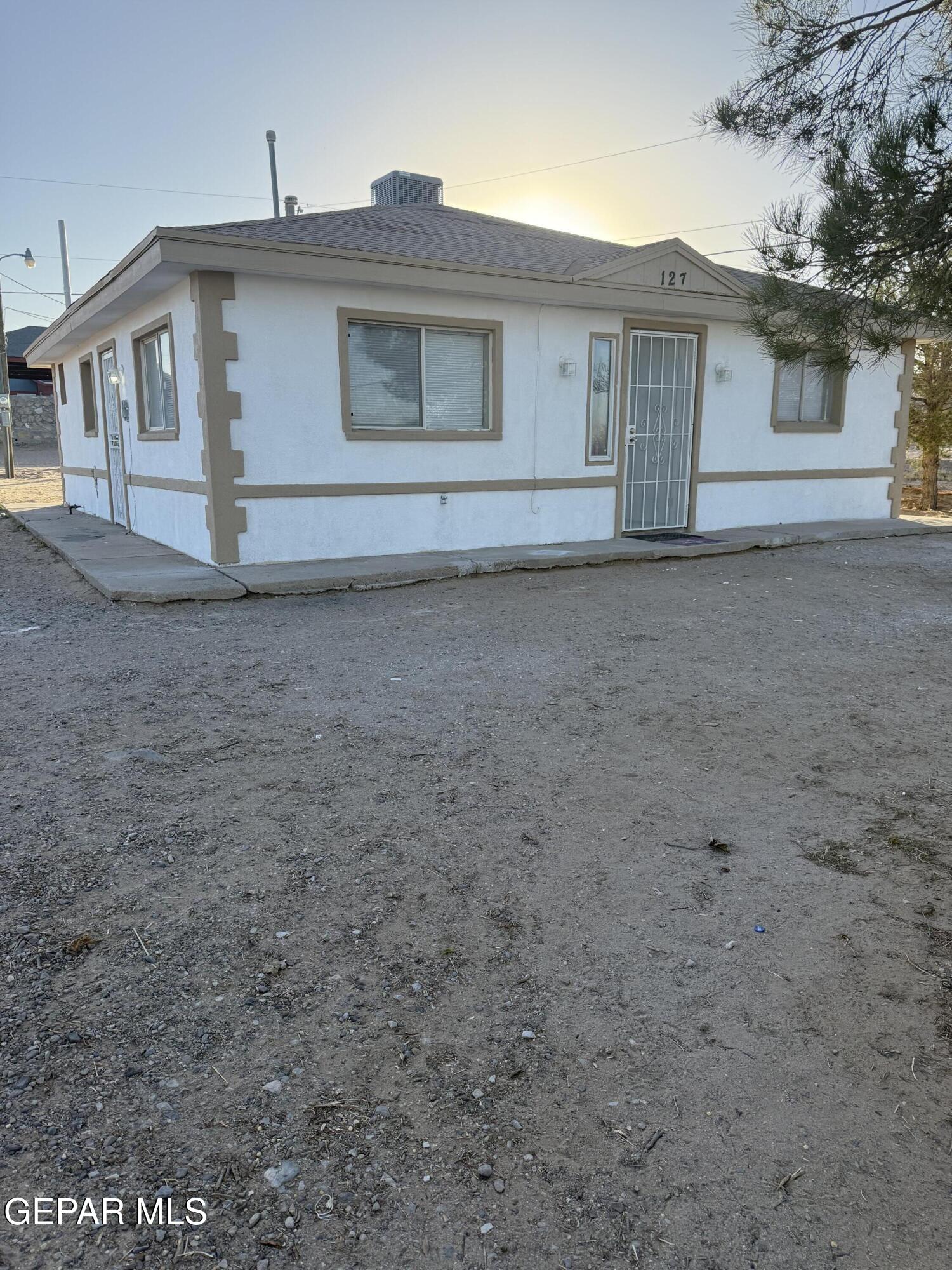 a view of house that has a small yard