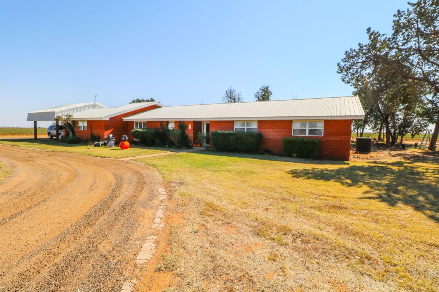 a front view of house with yard and car parked