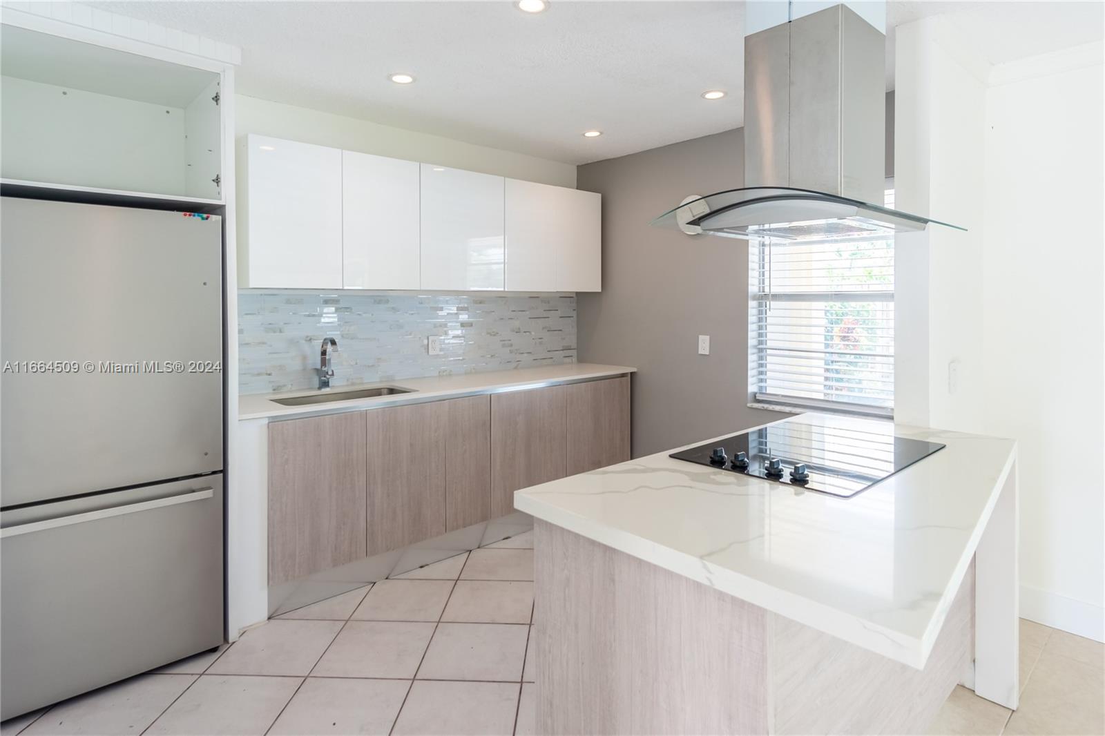 a kitchen with kitchen island a counter appliances a sink and cabinets