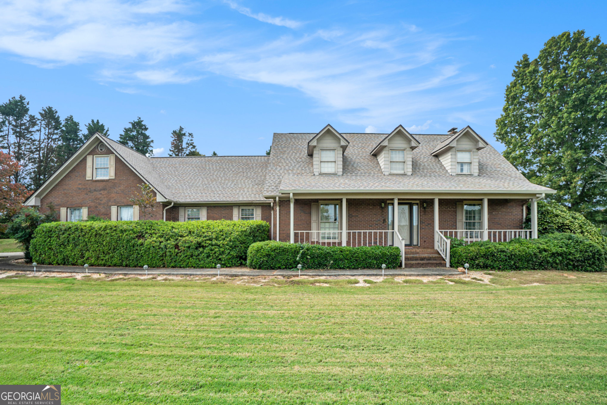 a front view of a house with garden