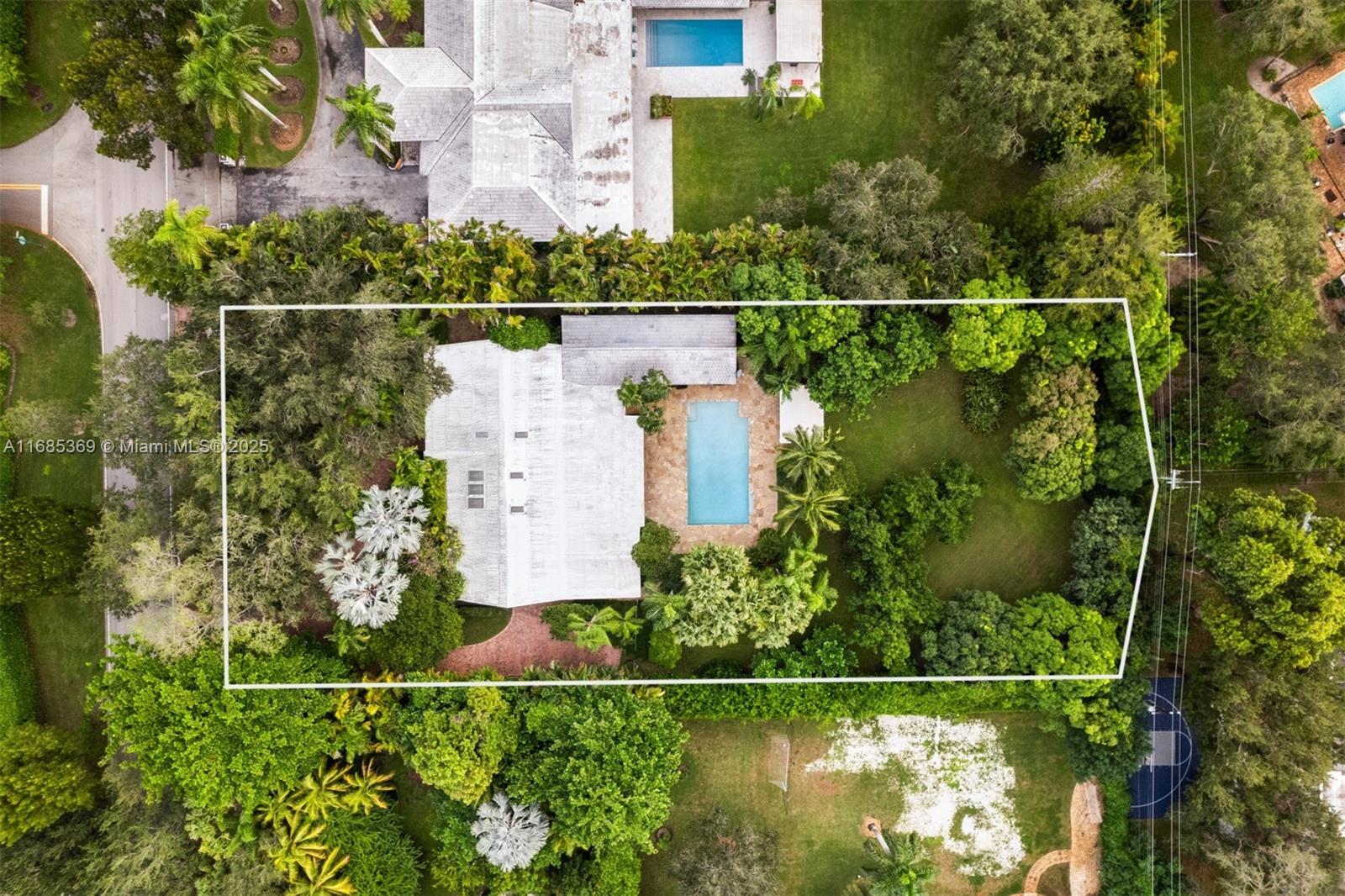 an aerial view of a house with a yard and a garden