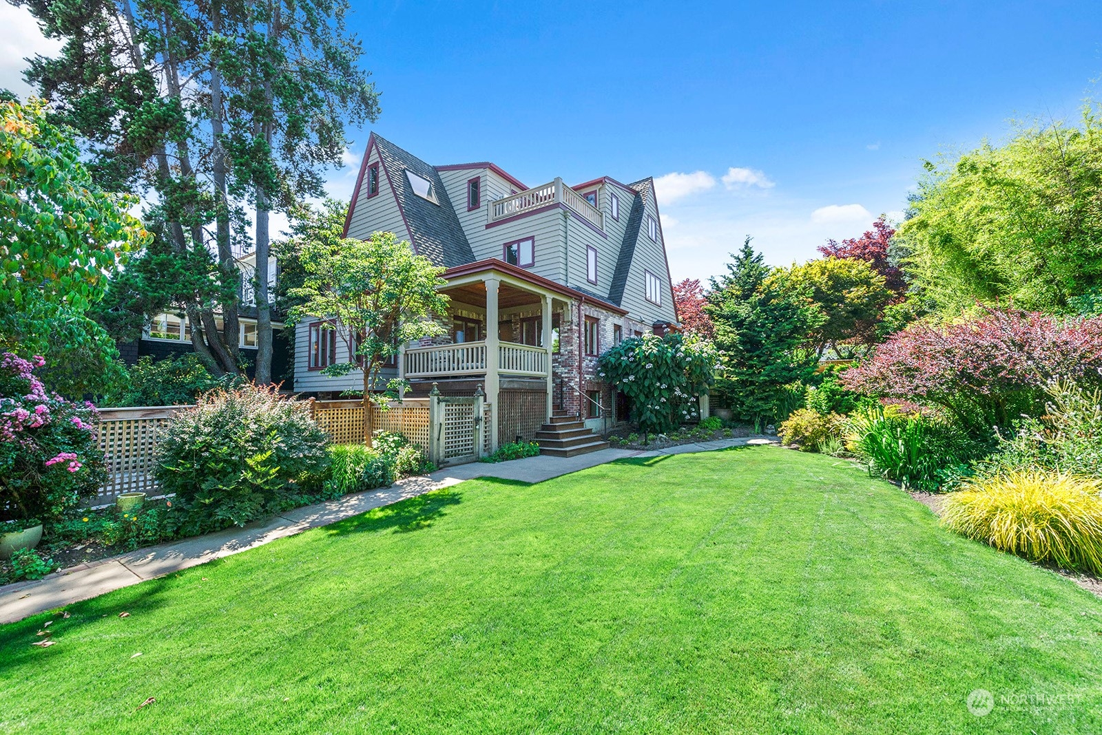 a view of a house with a big yard and potted plants