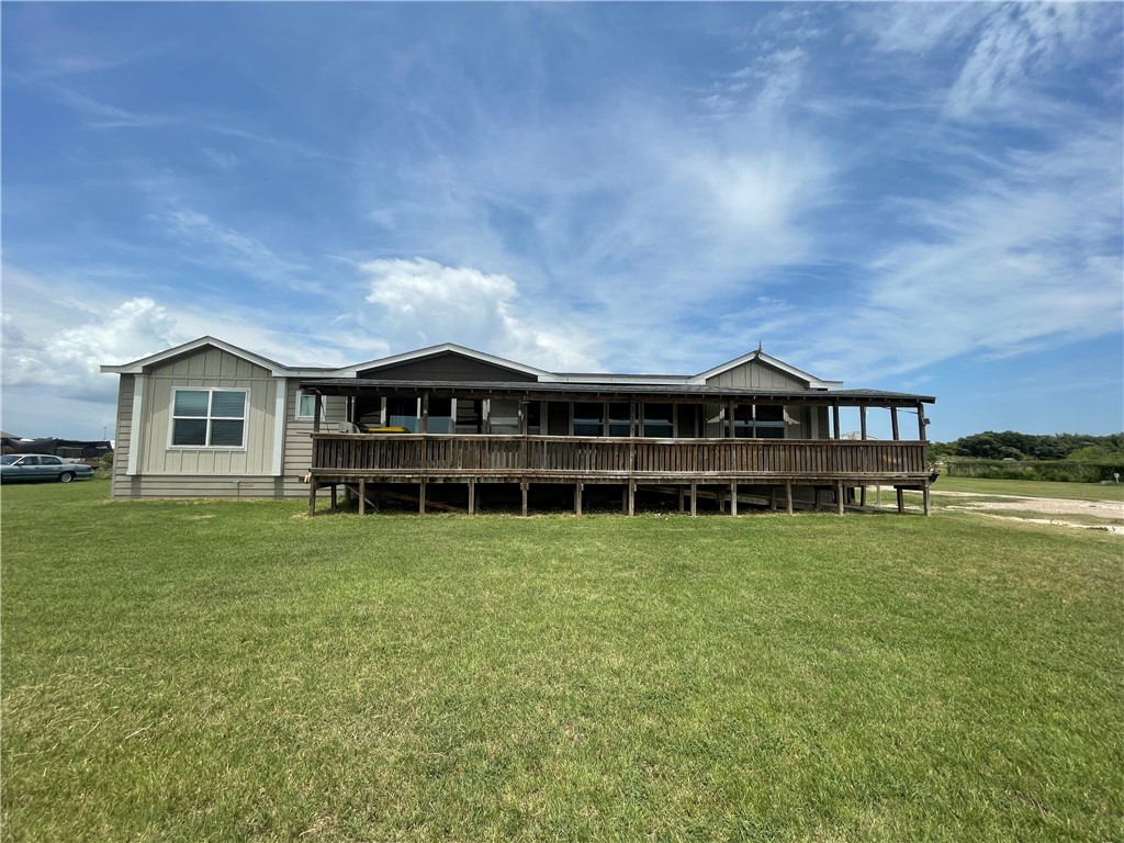 a view of a house with a yard and sitting area