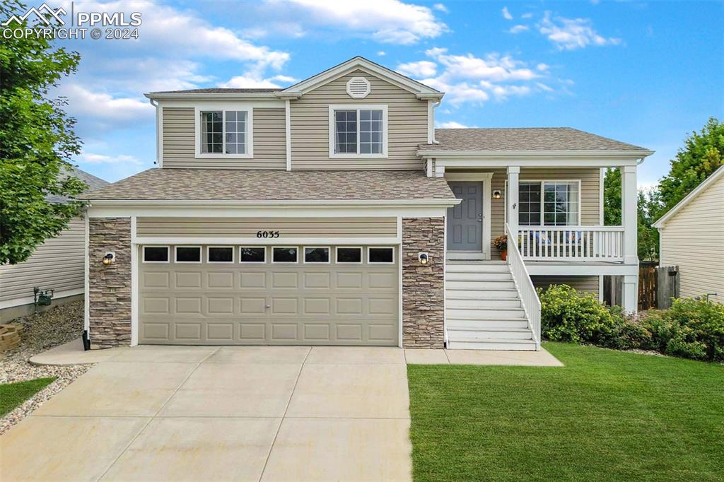 a front view of a house with a yard and garage