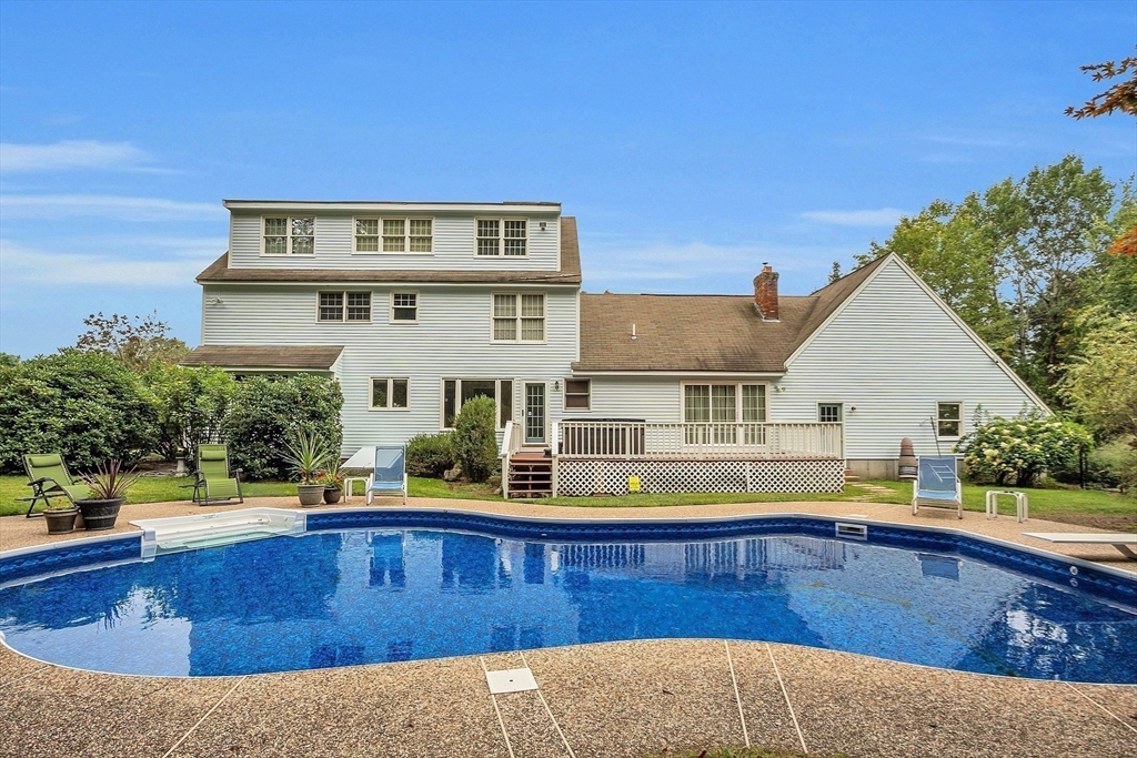 a view of a house with swimming pool and sitting area