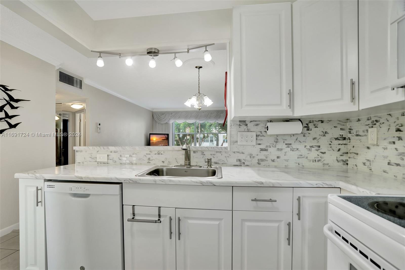 a kitchen with cabinets appliances and a counter space