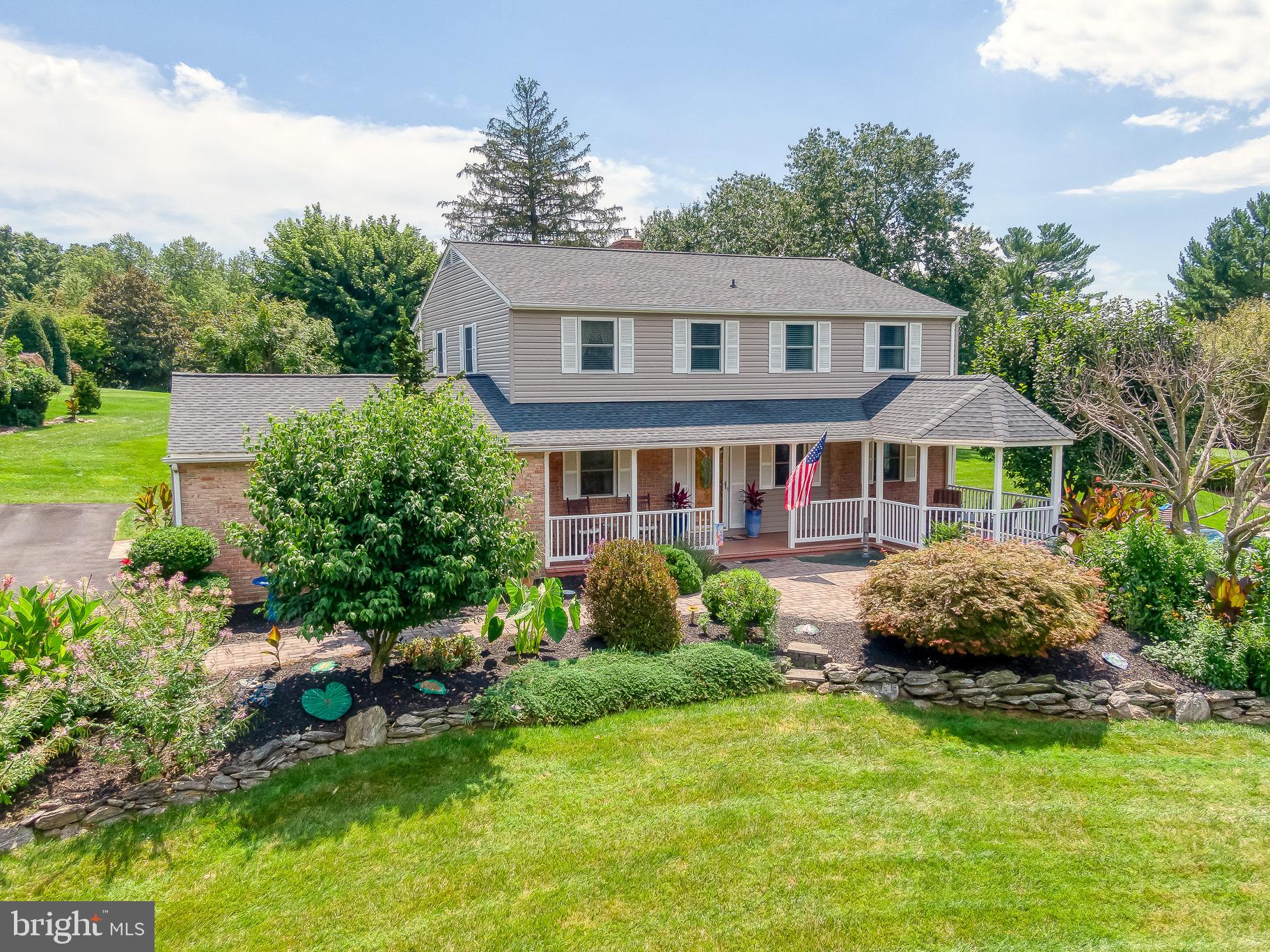 a front view of house with yard and green space