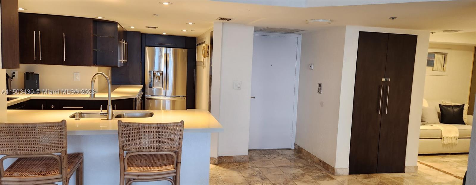 a kitchen with a refrigerator and a stove