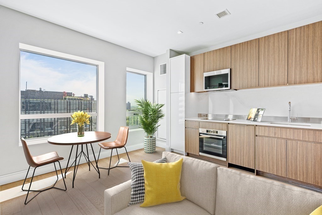 a kitchen with microwave cabinets and dining table