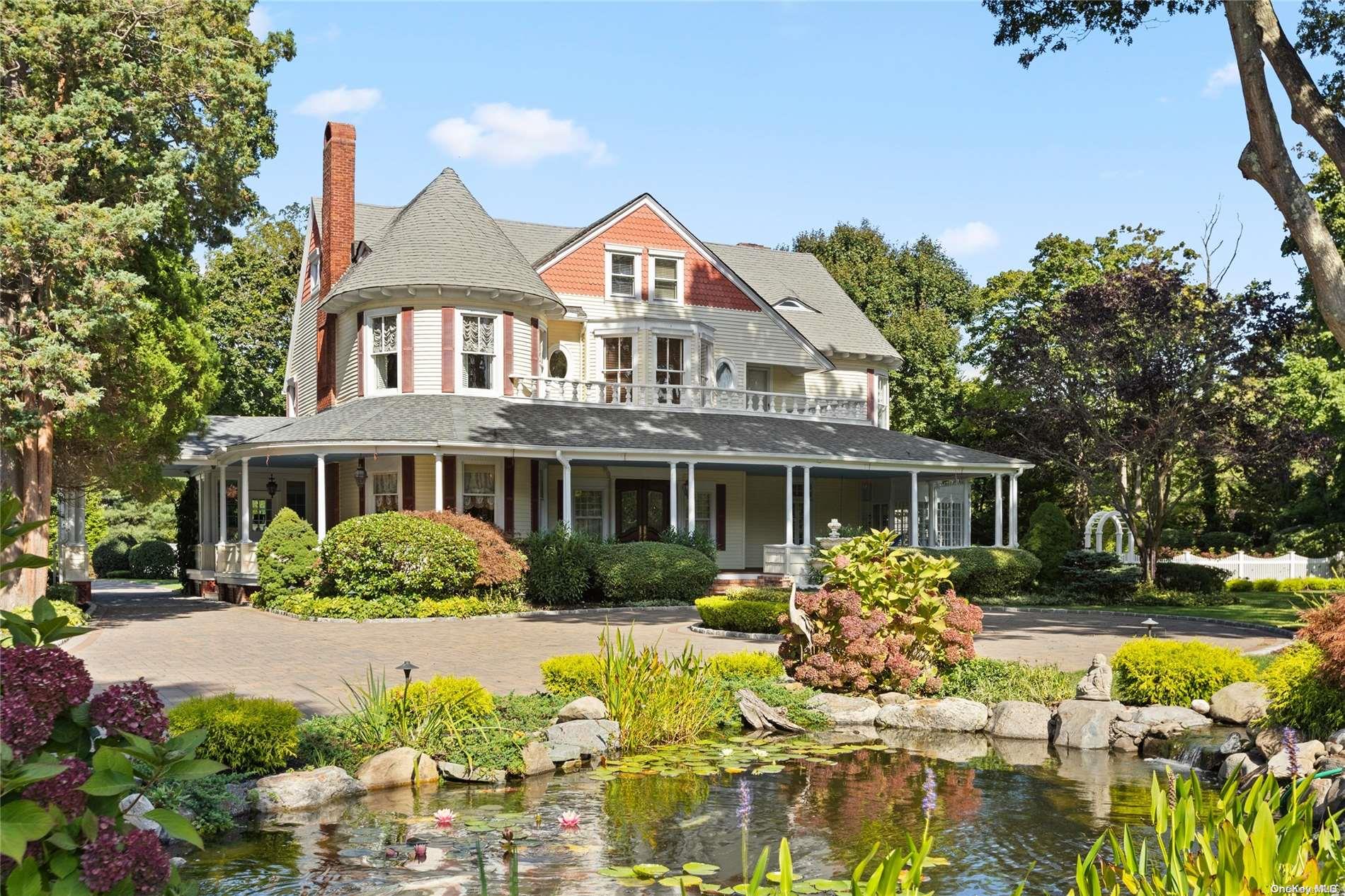 a front view of a house with a yard and fountain