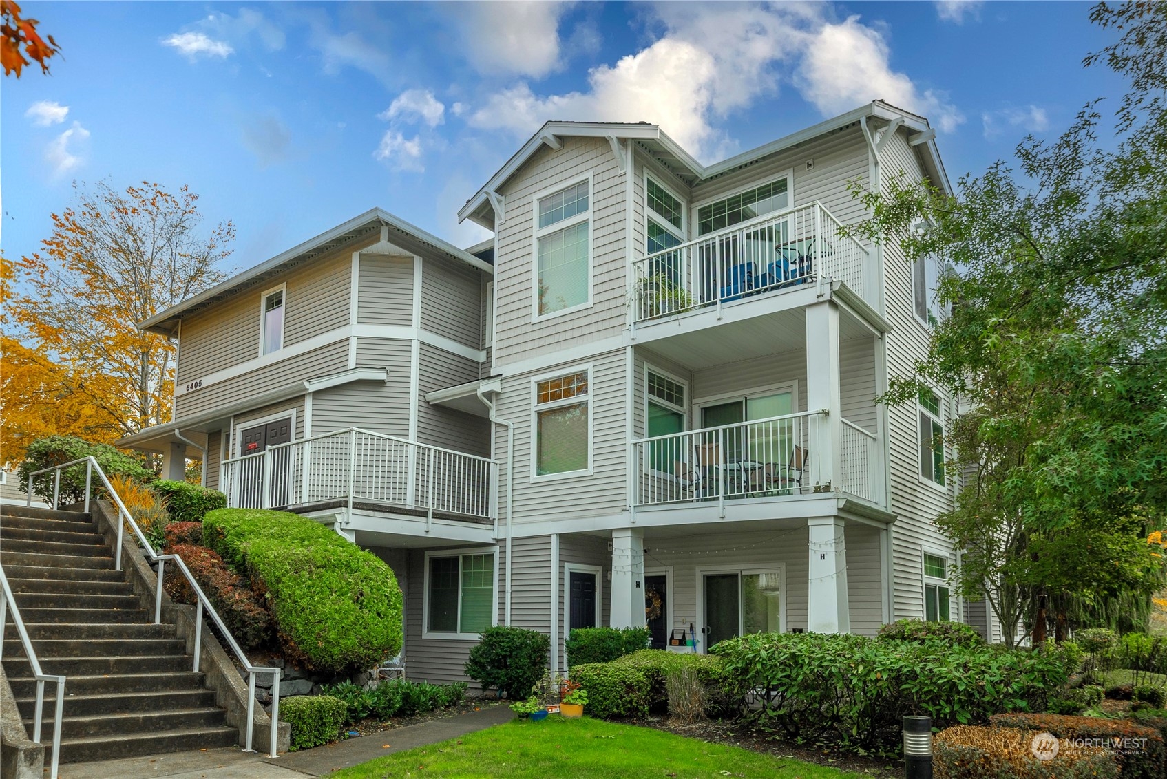 a front view of a residential apartment building with a yard