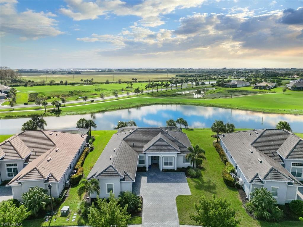 an aerial view of a house with a garden and lake view