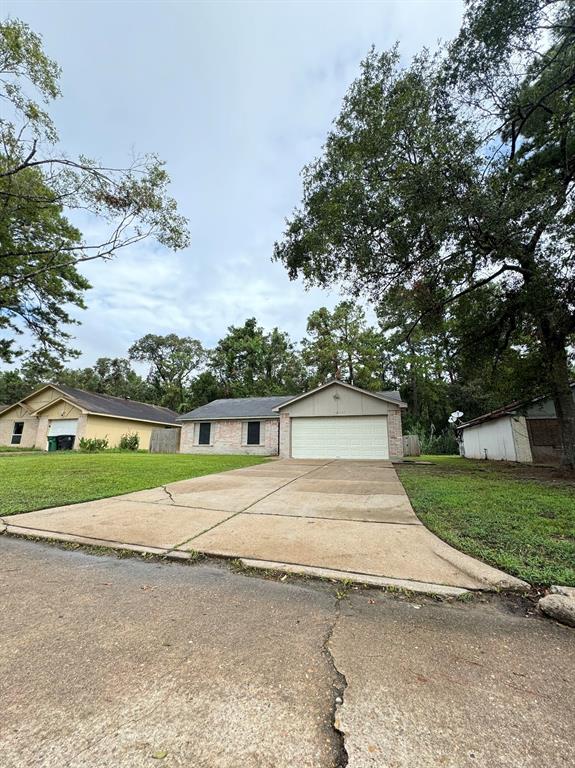 a view of a house with a yard and garage