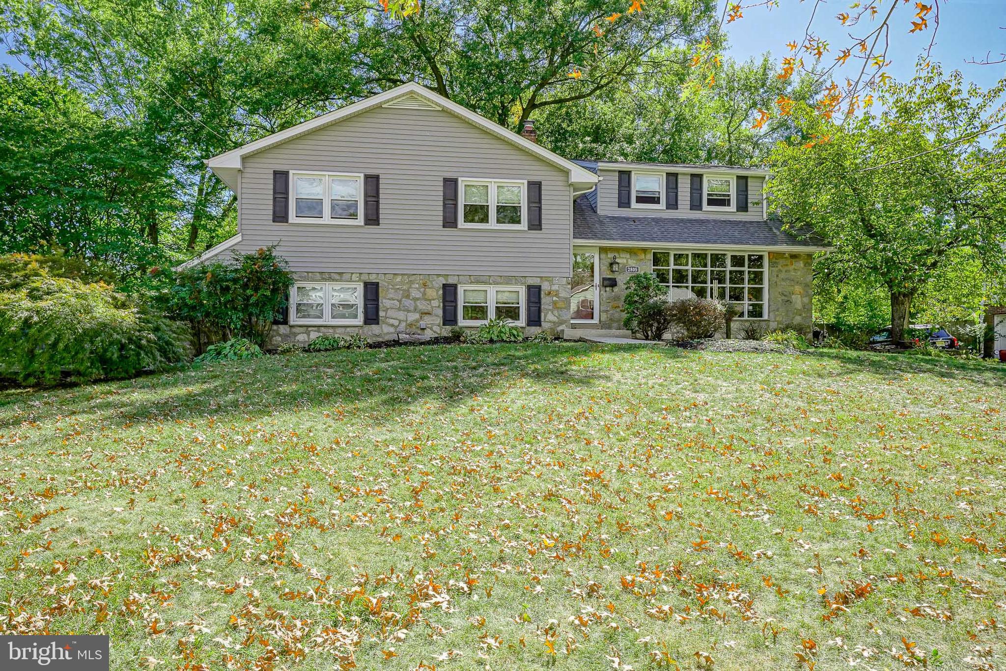 a house that has a tree in front of it