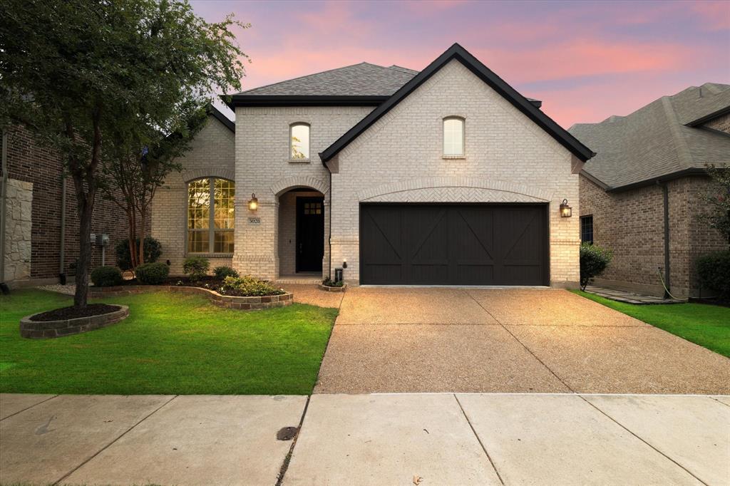 a front view of a house with yard and green space