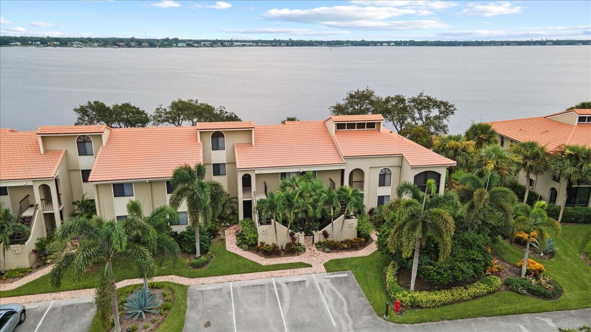 a aerial view of a house with a yard and lake view